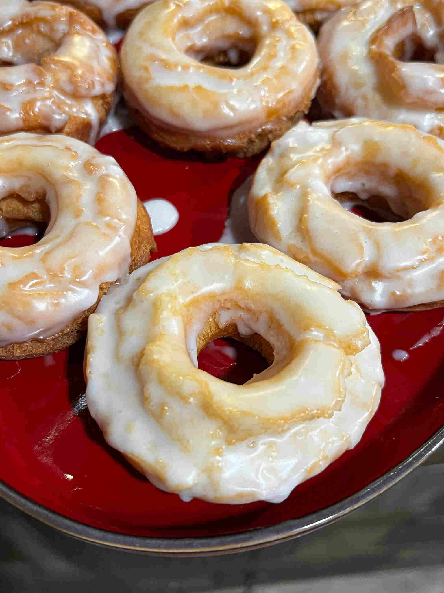 Homemade Old Fashioned Glazed Donuts on red dish